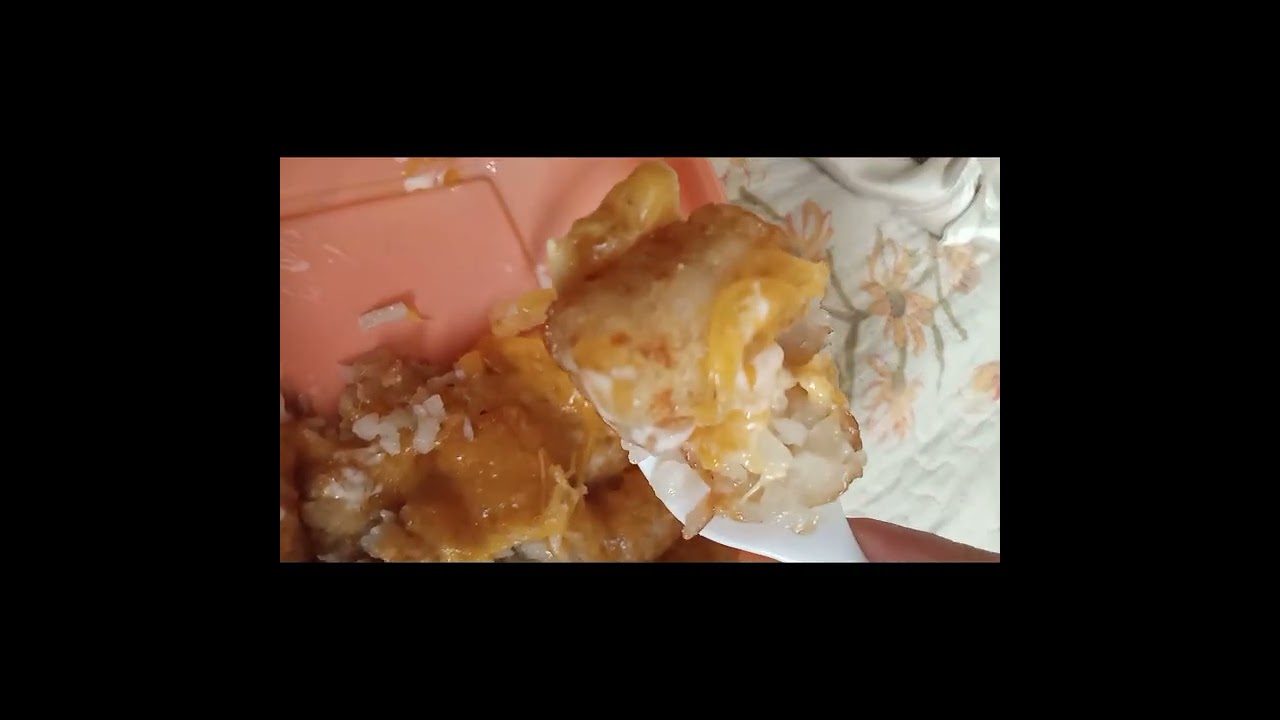 Eating cheesy tater tots with ranch 
