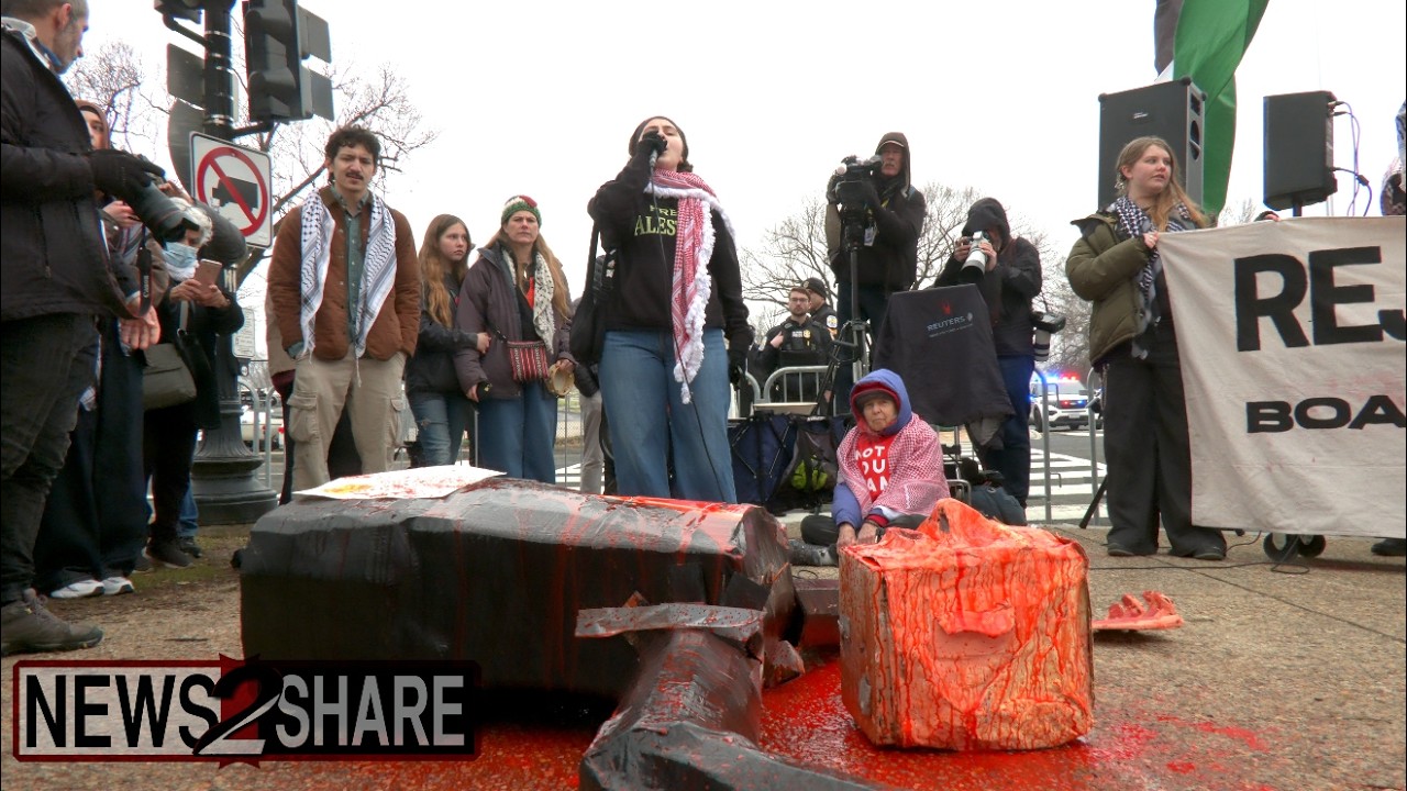 Protesters throw, bloody effigy of Trump outside 