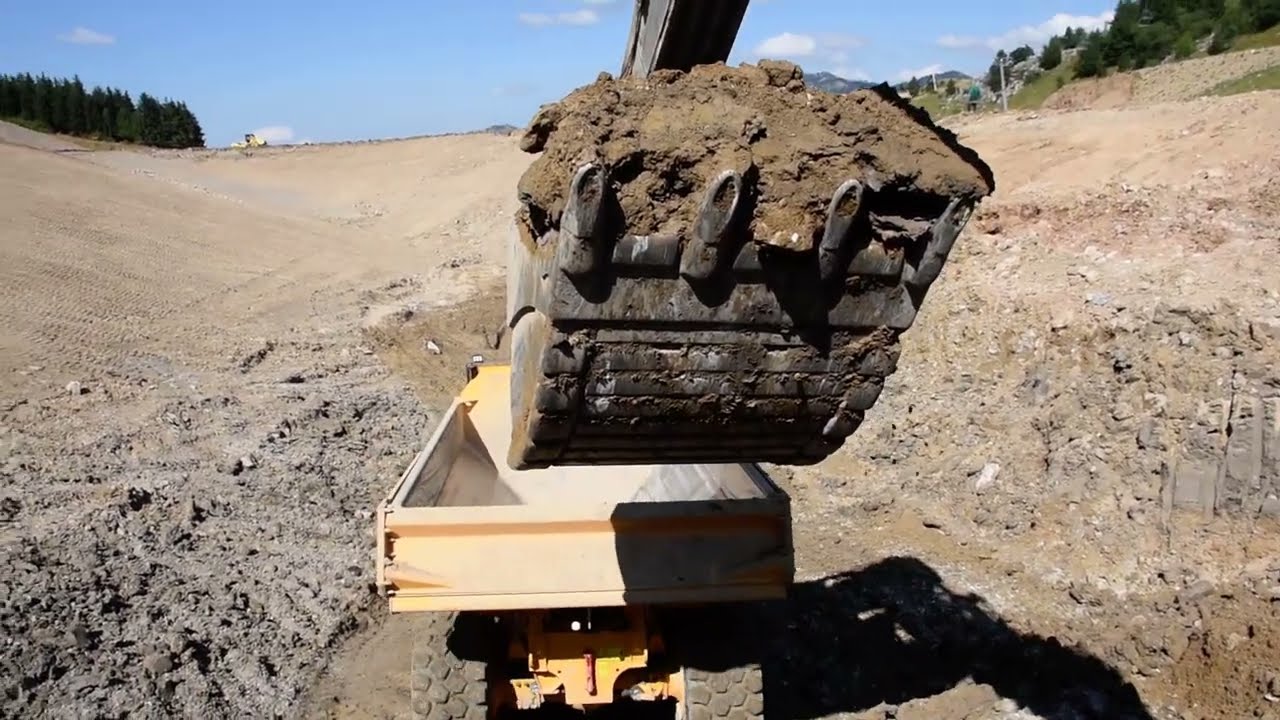 Volvo EC750E loading 745 and A40G from cab