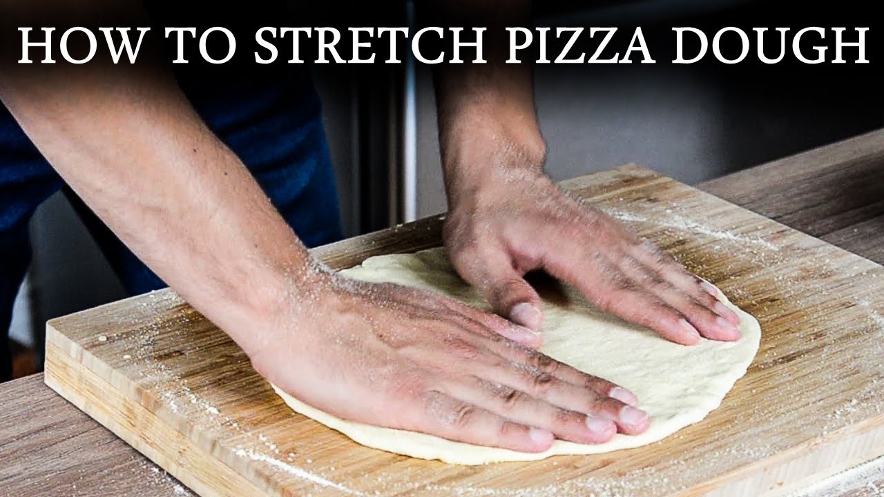 How To Stretch THIN CRUST Pizza Dough By Hand (For Beginners)
