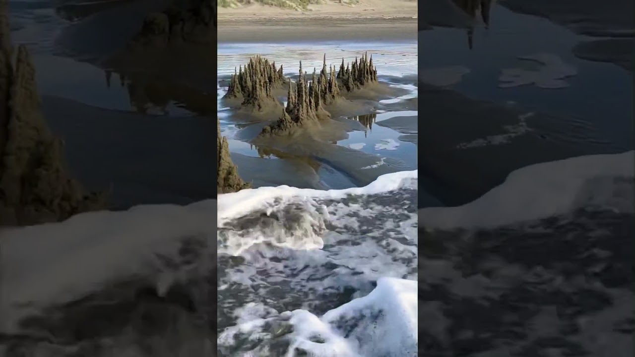 Sandcastle destroyed by a wave