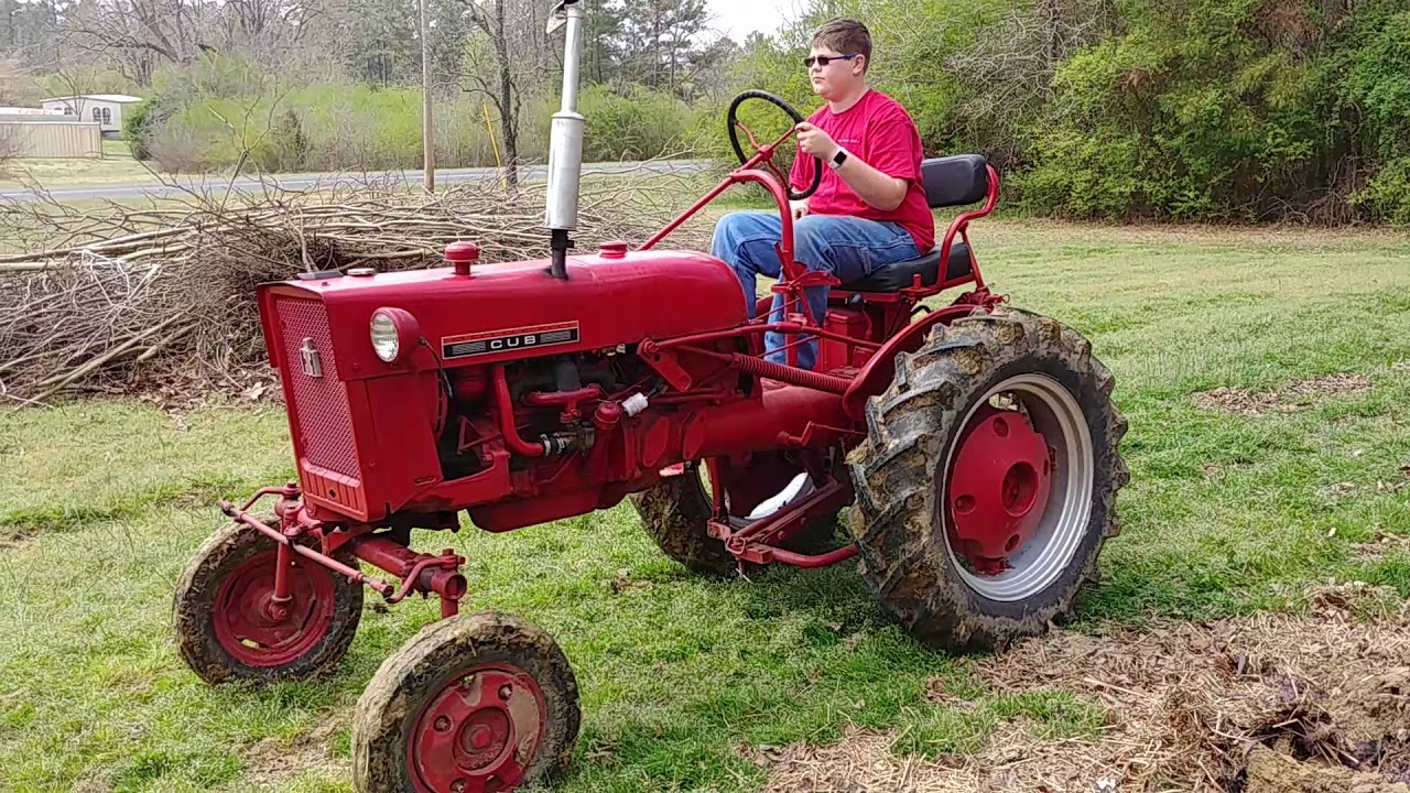 Cub Tractor breaks land with single bottom plow IH l-f194