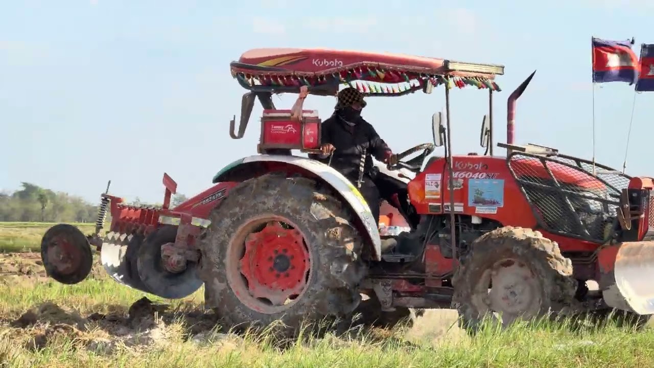 Farmer plow fields with Kubota tractor m6040su 