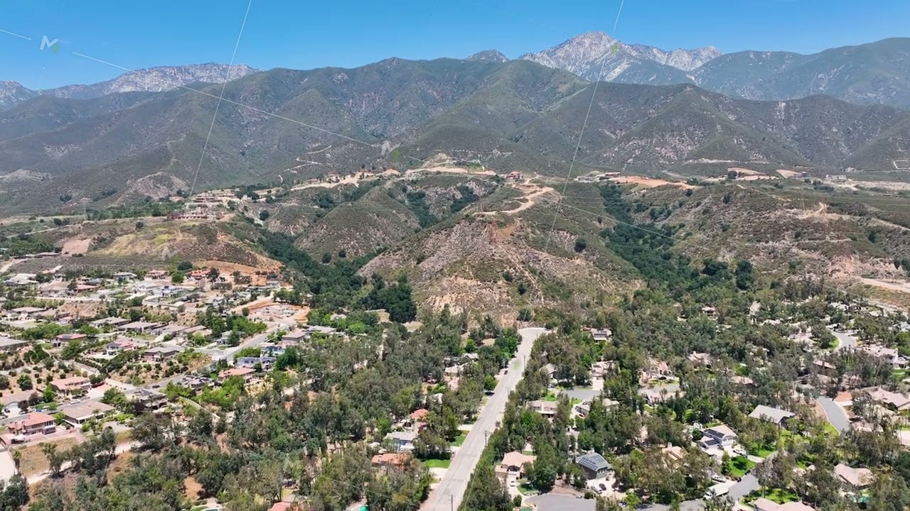 Aerial view of wealthy Alta Loma community and mountain range.