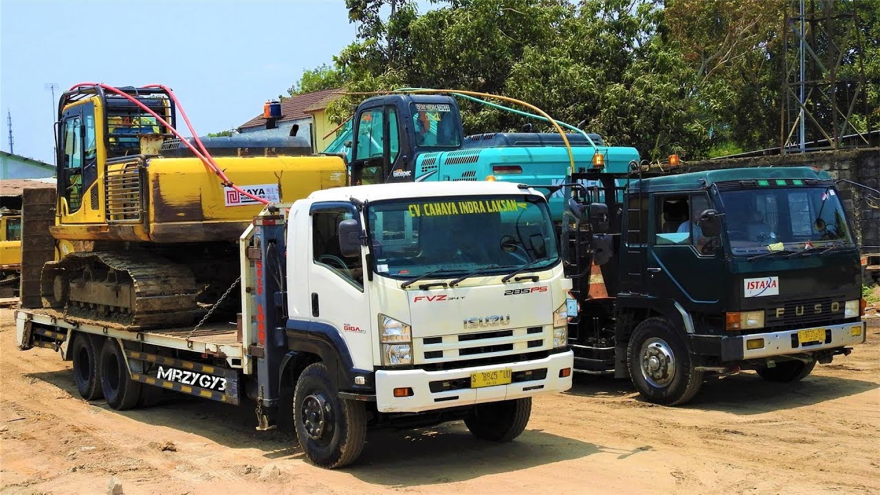 Two Excavators Transport By Self Loader Trucks Komatsu PC200 Kobelco SK200