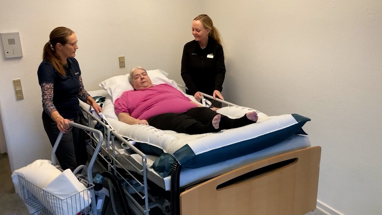 HoverSling Repositioning Sheet - Higher up in bed with two caregivers
