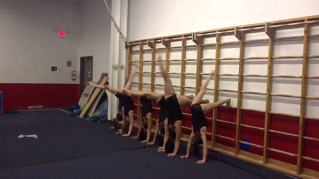 Using the stall bars to train the 180 split in a handstand!