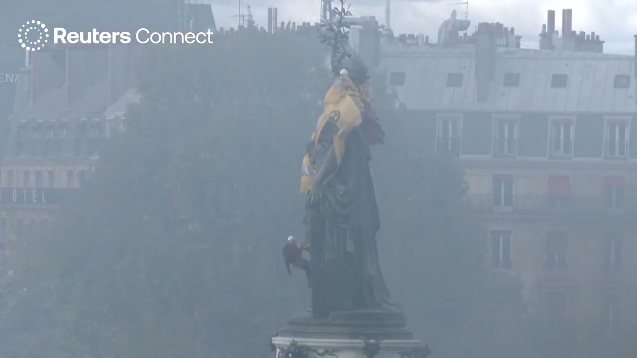 MOMENT: Protesters drape giant yellow vest over Paris statue