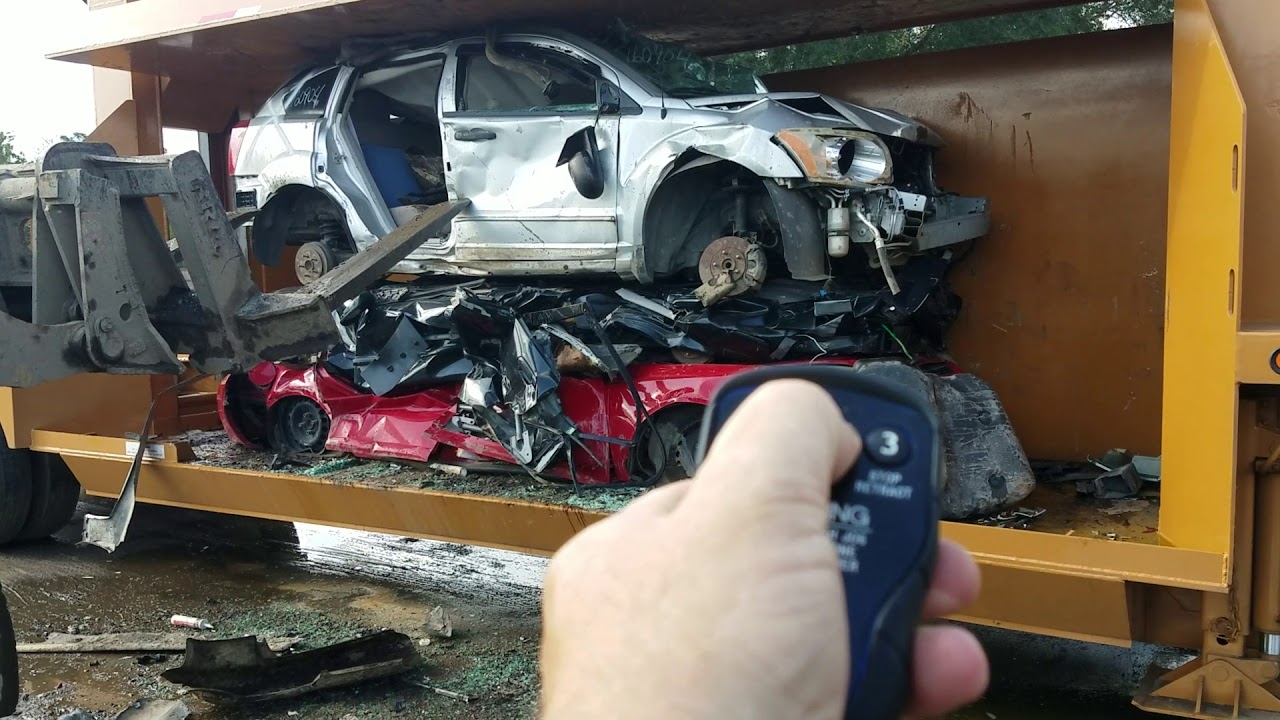 Big mac car crusher @ AA Auto Salvage & Recycling LLC with remote