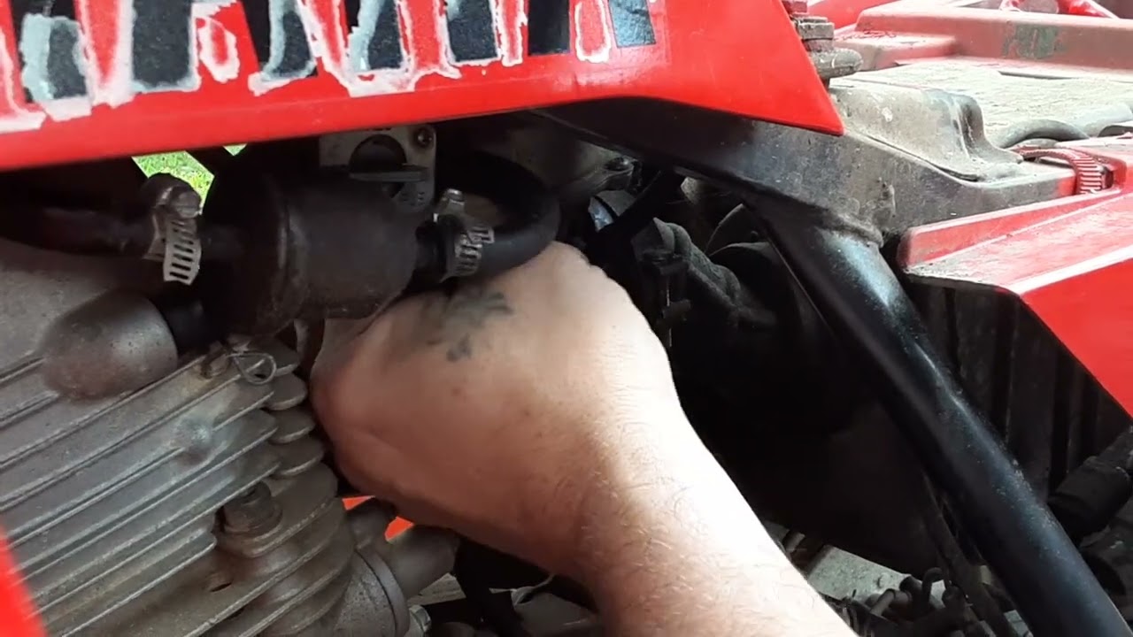 removing carb on Yamaha beartracker to replace intake boot 1 of 3
