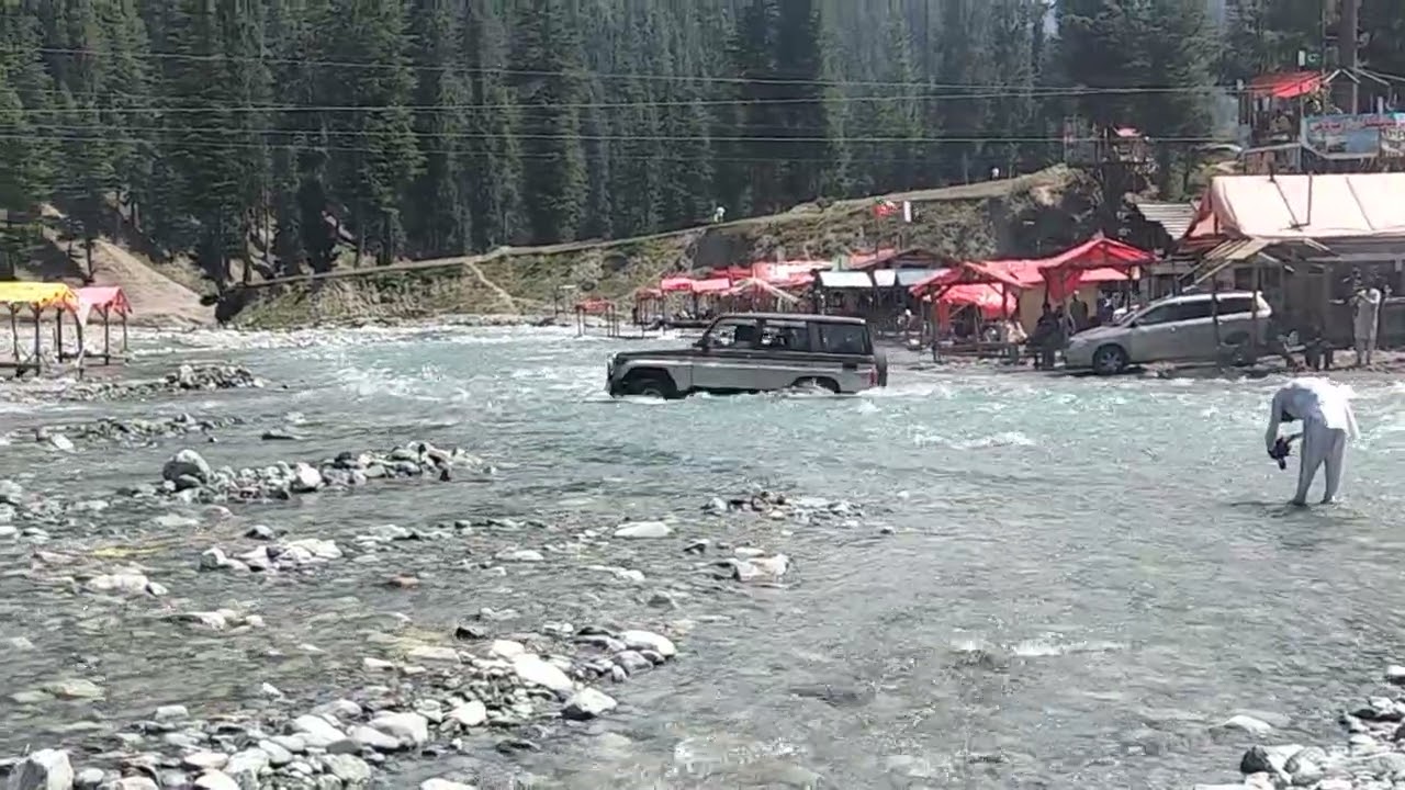 Jeep crossing river at Blue Water Kalam 