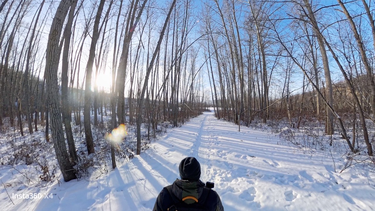 ENJOYING SUNNY COLD WEATHER ON A SNOWY TRAIL