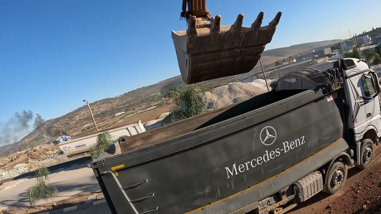 Hitachi Excavator in Action with Mercedes-Benz Truck