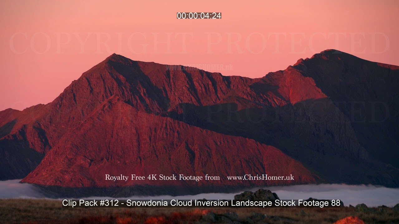 Mount Snowdon, Crib Goch and Garnedd Ugain stock footage above a cloud inverision in red light