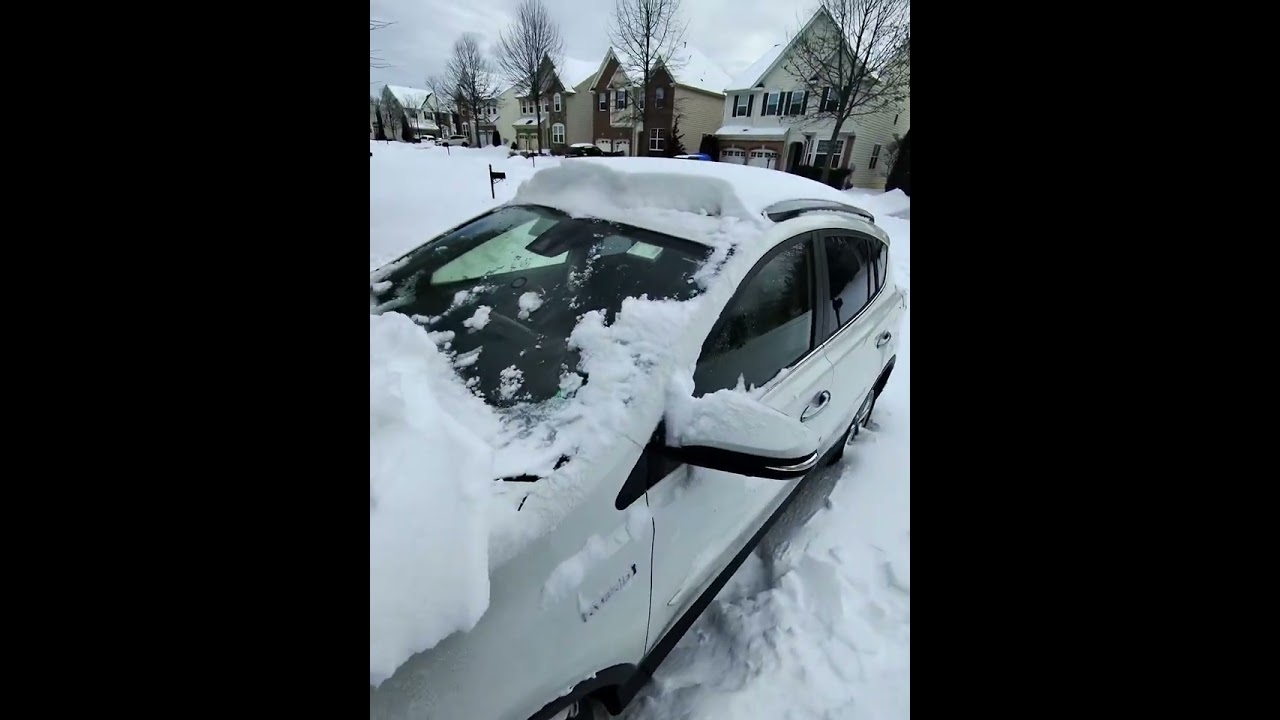 Cleaning car in the Snow