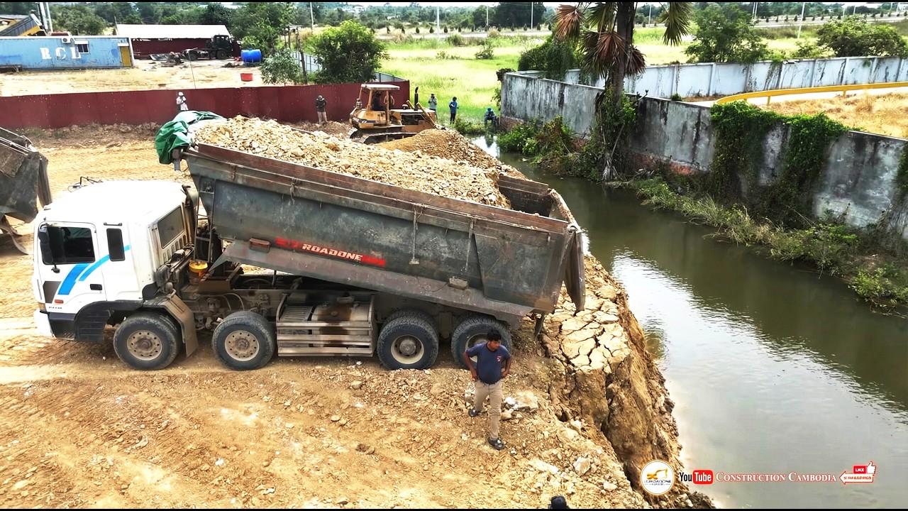 Nicely Complete Landfill a Pond into Solid Ground Using Dozer Expertise and 25-Ton Dump Trucks