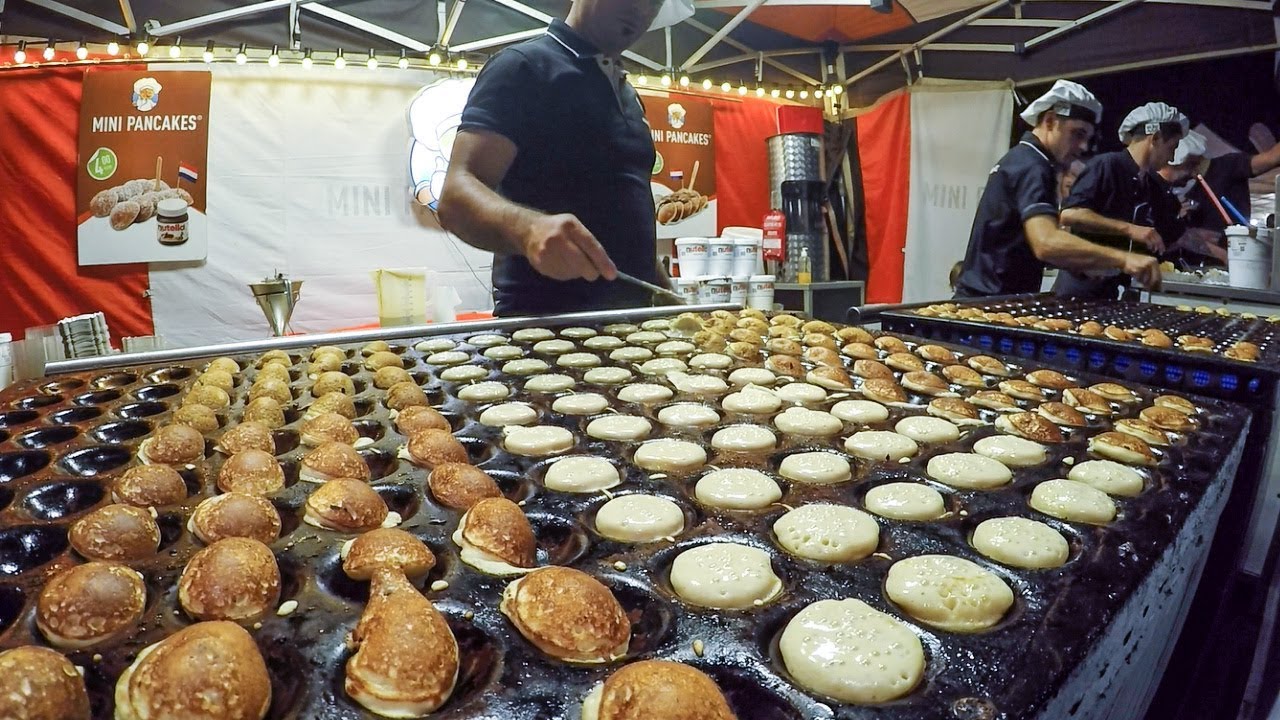 Dutch Street Food. Cooking Sweet Pancakes Poffertjes with Chocolate
