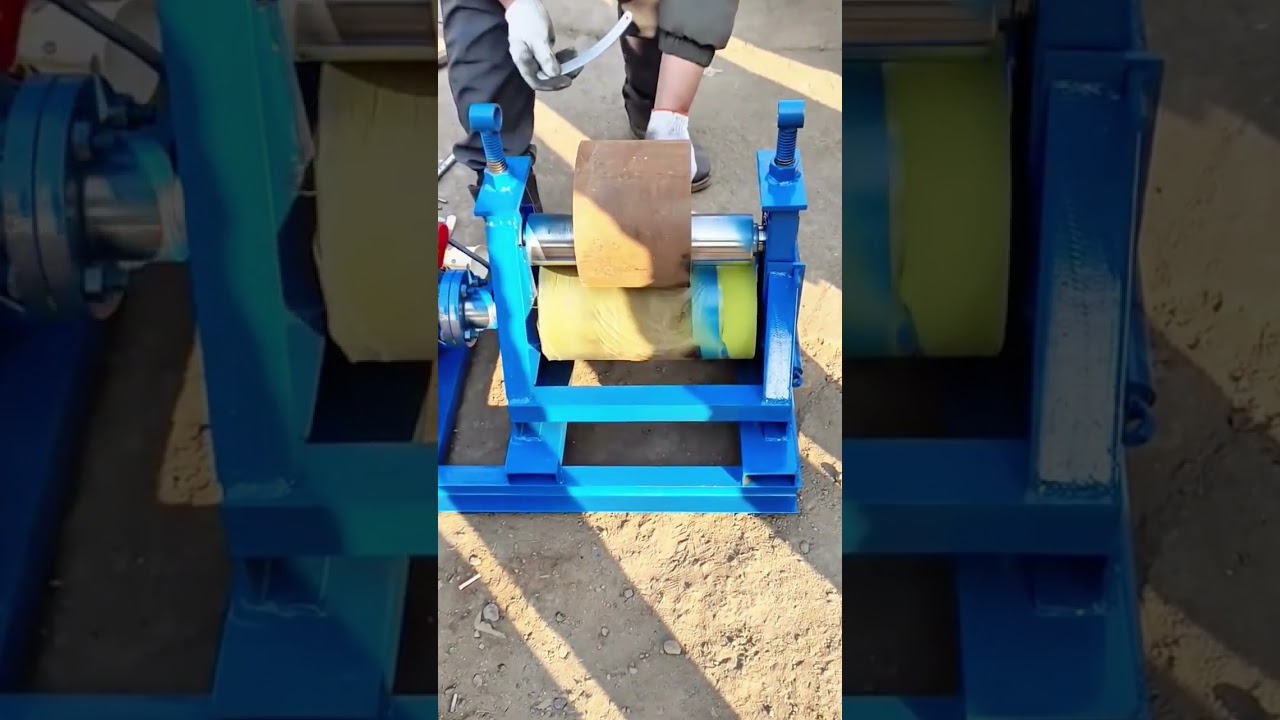 A Worker Operating a Rolling Machine to Bend or Shape Metal Plates