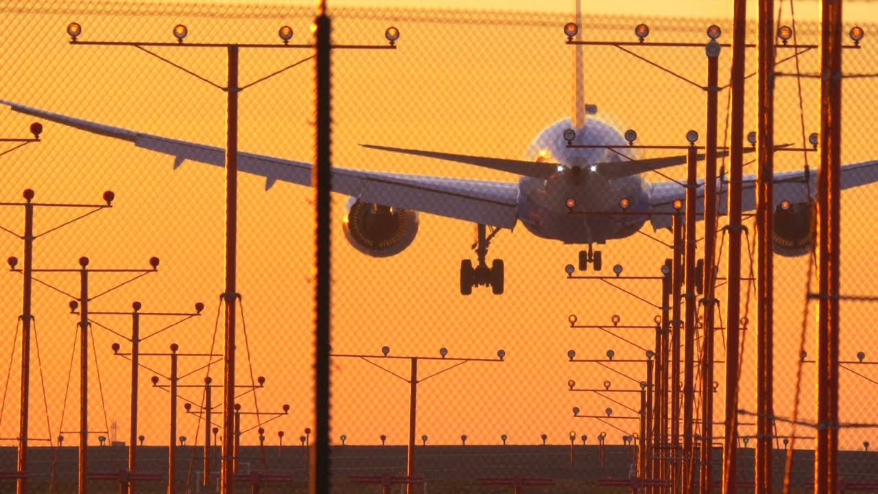 4k Plane Landing at Sunset Light Sky