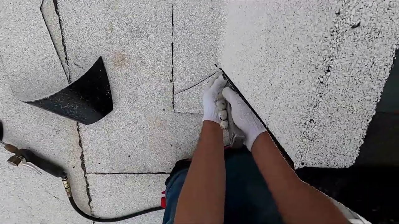 Torching ULTRA WHITE cap sheet details on the curb