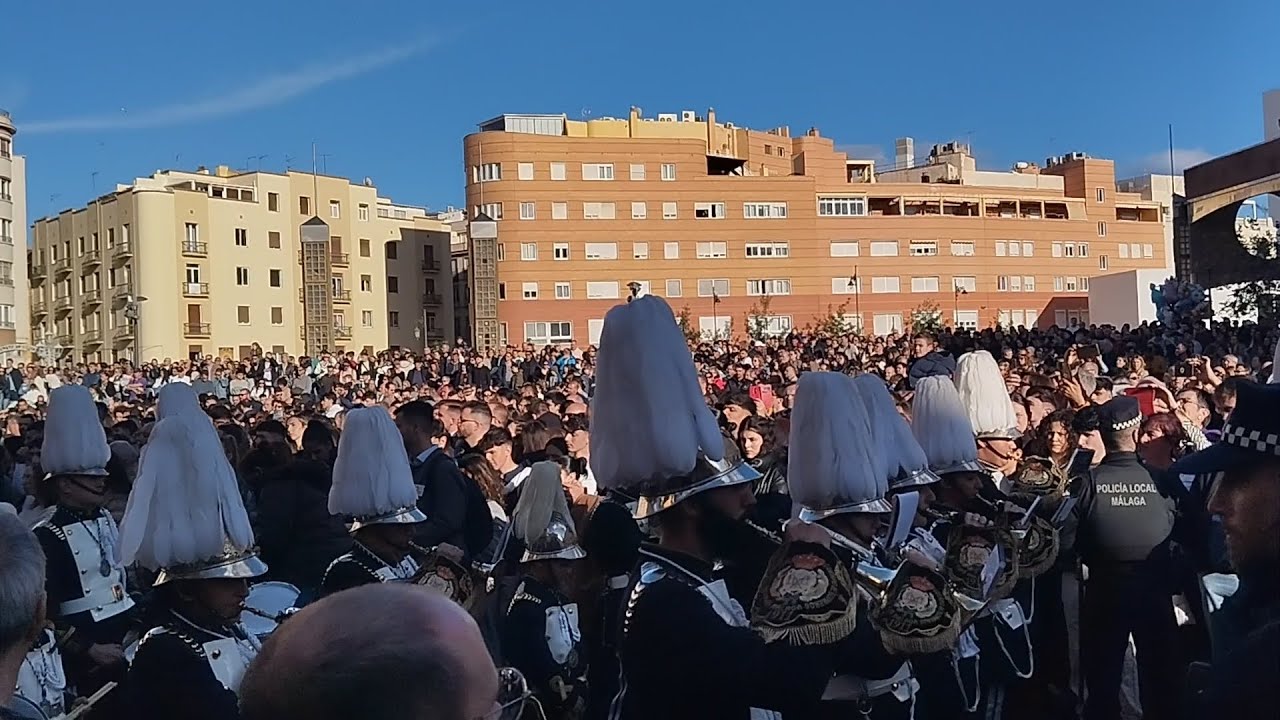 Banda CCTT de Bomberos junto a la cruz guía de Humillación. Semana Santa de Málaga, 2024.