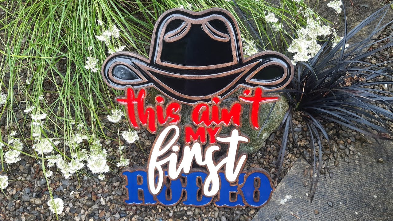 This Ain't My First Rodeo routed out on plywood and inlayed with resin. .router/scroll saw project.