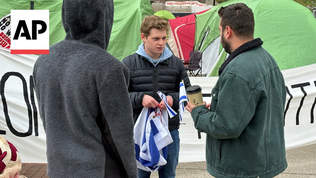 Israel supporter stands near pro-Palestinian encampment at University of Michigan