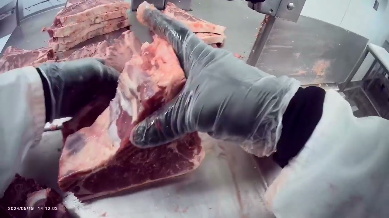 Cutting a short loin into steaks 