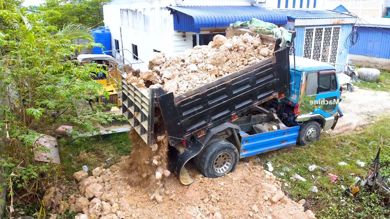 The small land flood filling up by bulldozer and dump truck cooperate in the project for successful