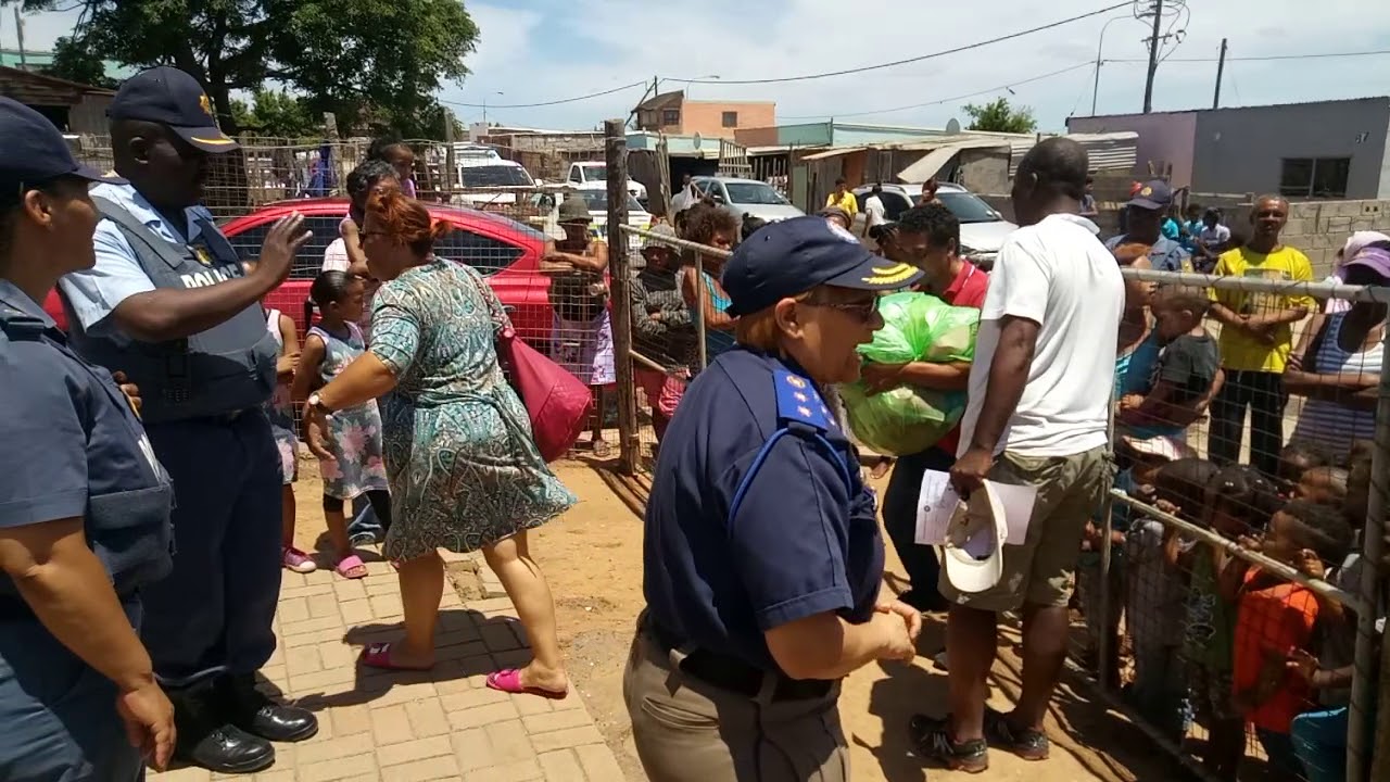 Handing out clothing in missionvale with law enforcement