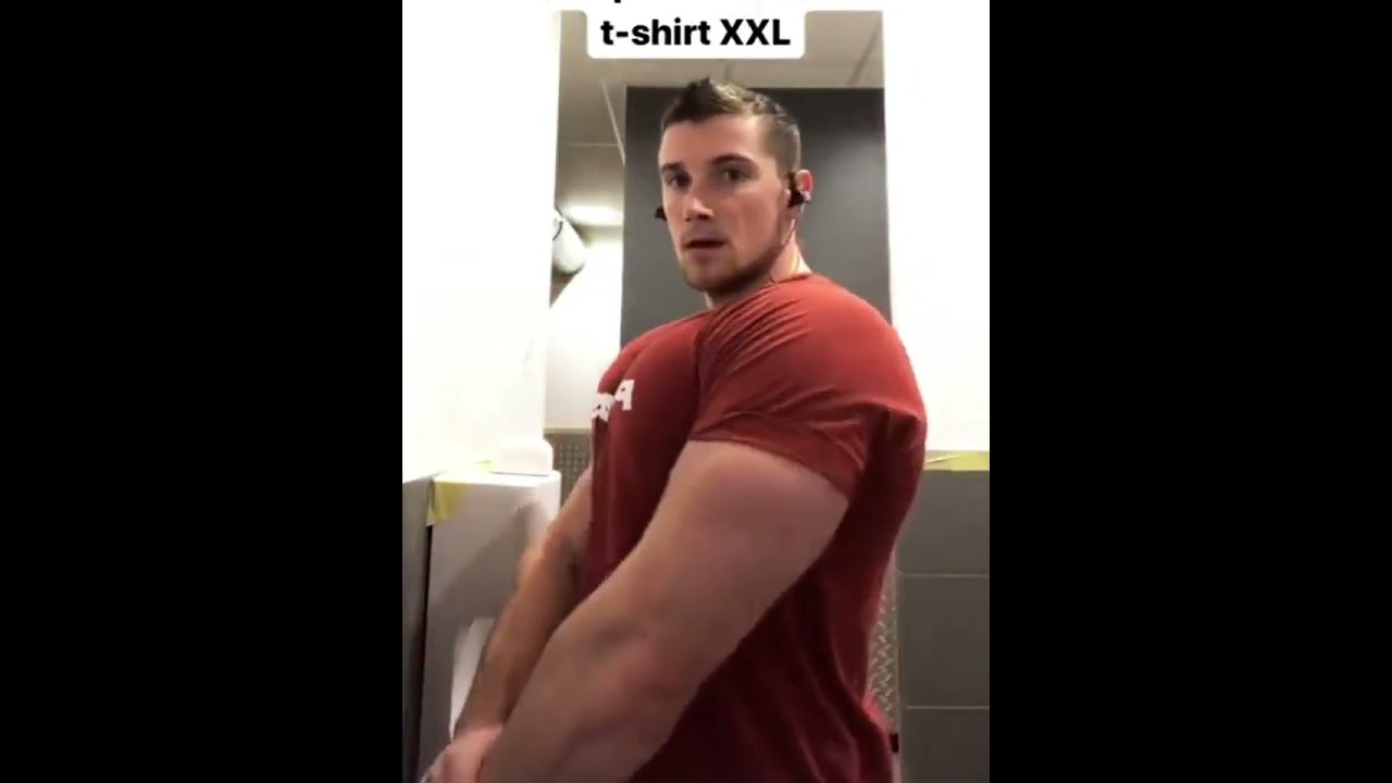 Giant muscle bull Joffrey Vassaux in orange shirt flexing giant muscles