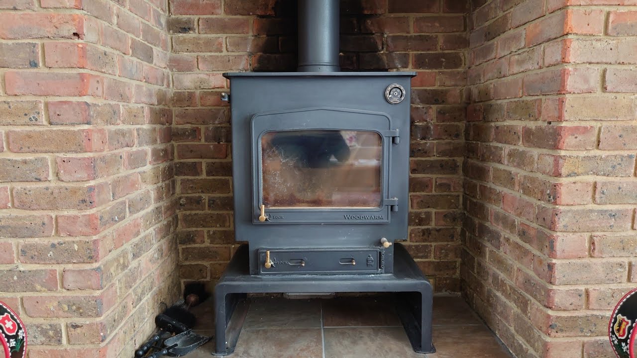 SWEEPING A WOODWARM FIREVIEW WOOD BURNING STOVE.