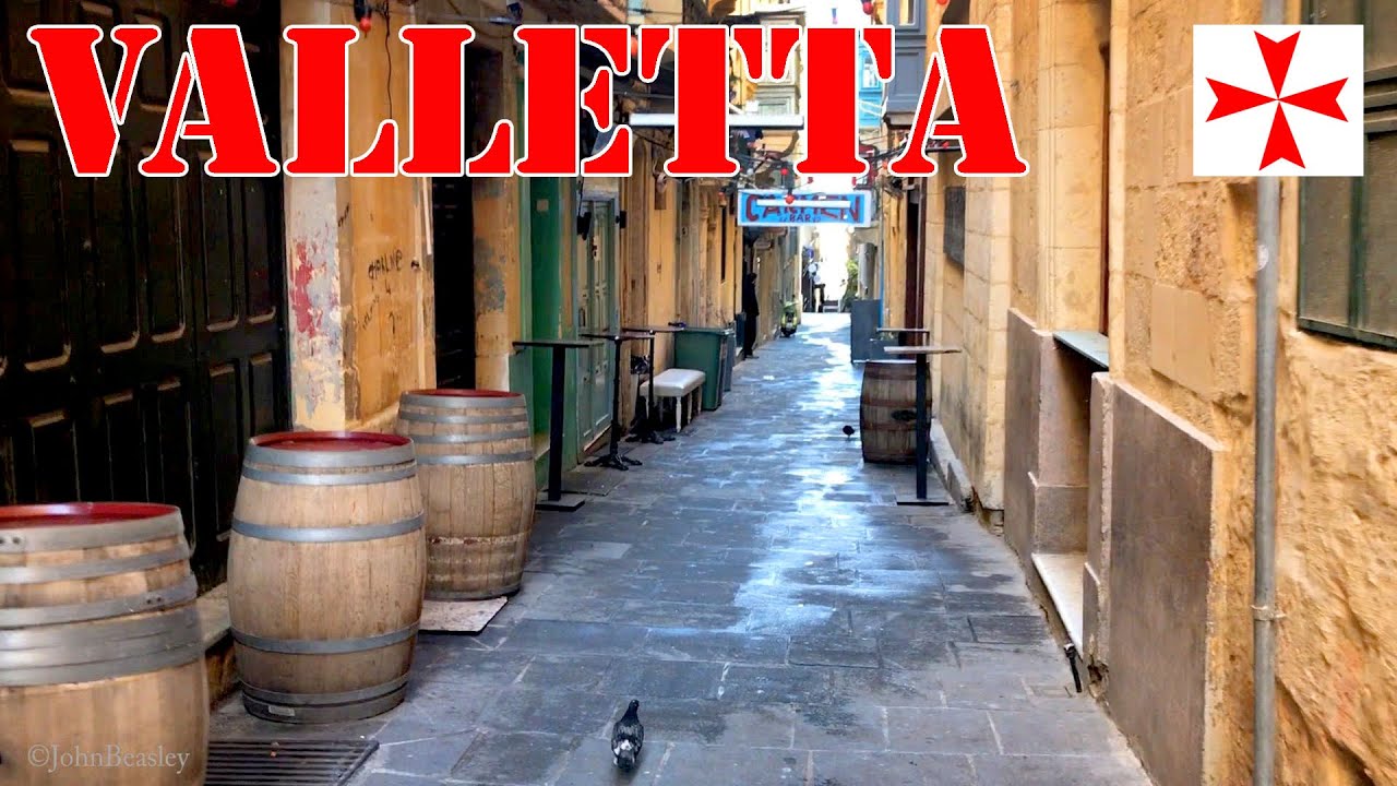 Valletta in Malta a tourist walk down historic Strait Street to the notorious Gut area.