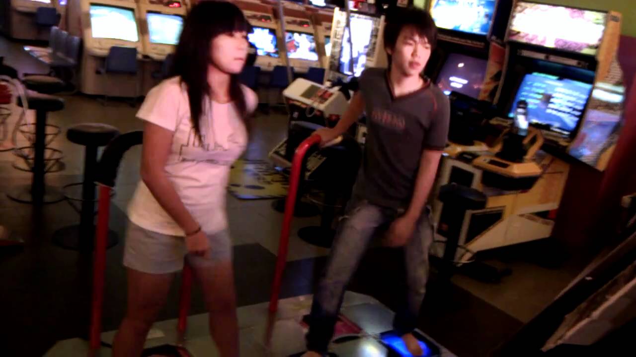 short girl playing the ddr machine