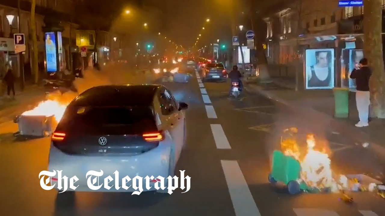 Paris protests: Drivers swerve through burning streets