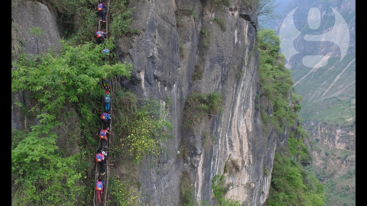 Chinese children climb 800m cliff to get home from school