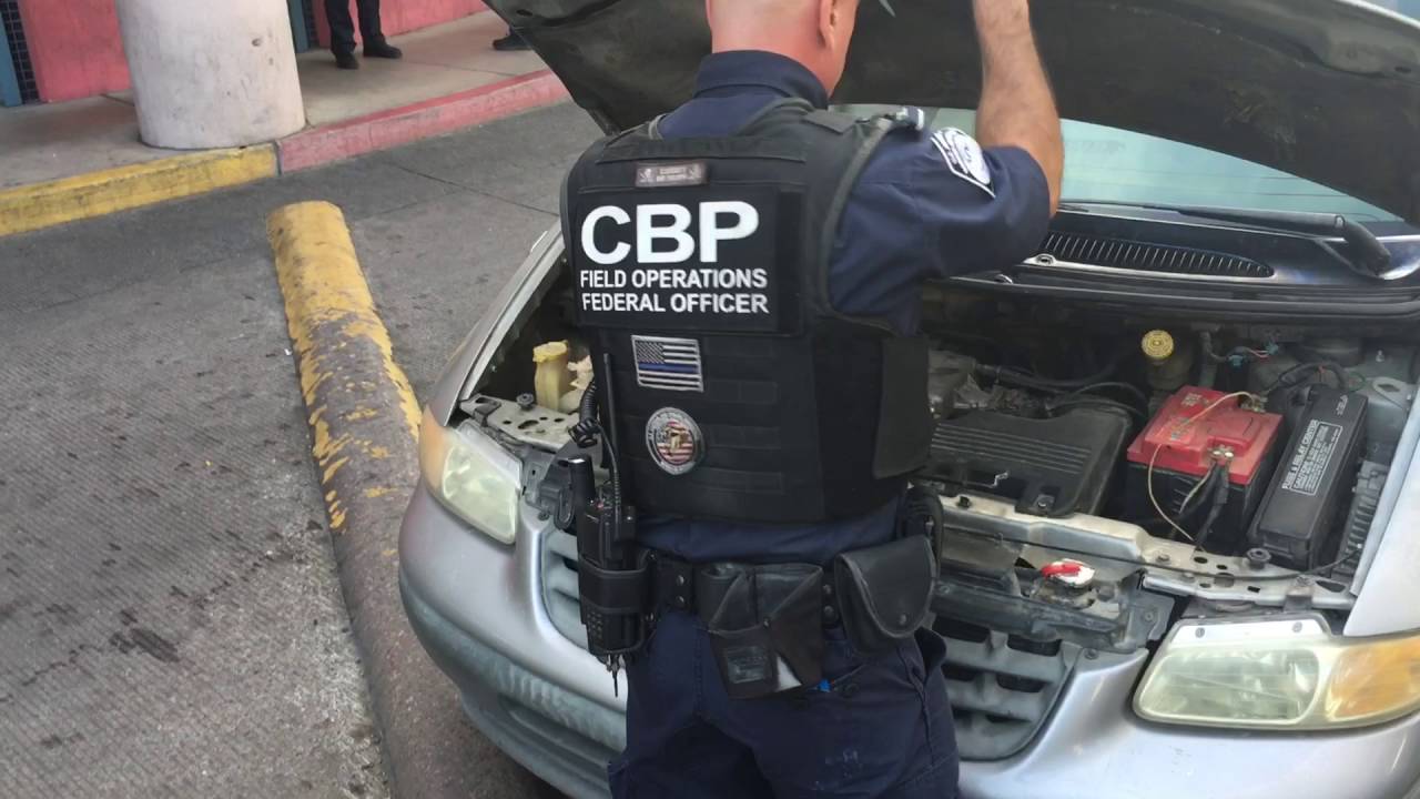 Customs officers inspect vehicles at a Nogales port of entry