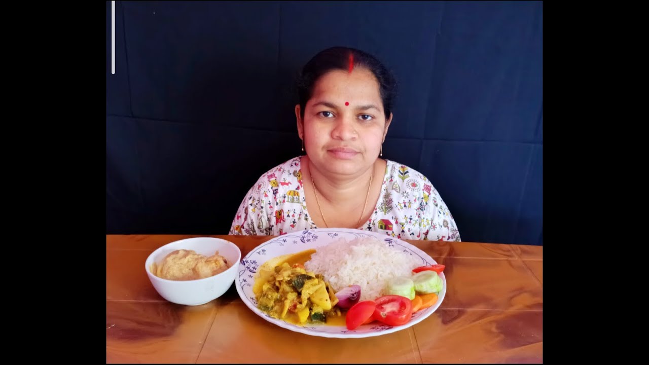 Basanti eating rice, mushroom jhal, egg posto and salad