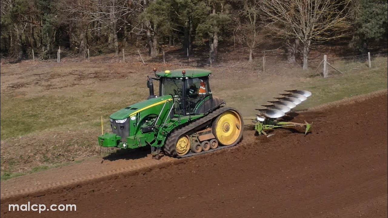 John Deere JD 8360RT tracked tractor ploughing with a 6 furrow Dowdeswell 145 & trailed coil packer.