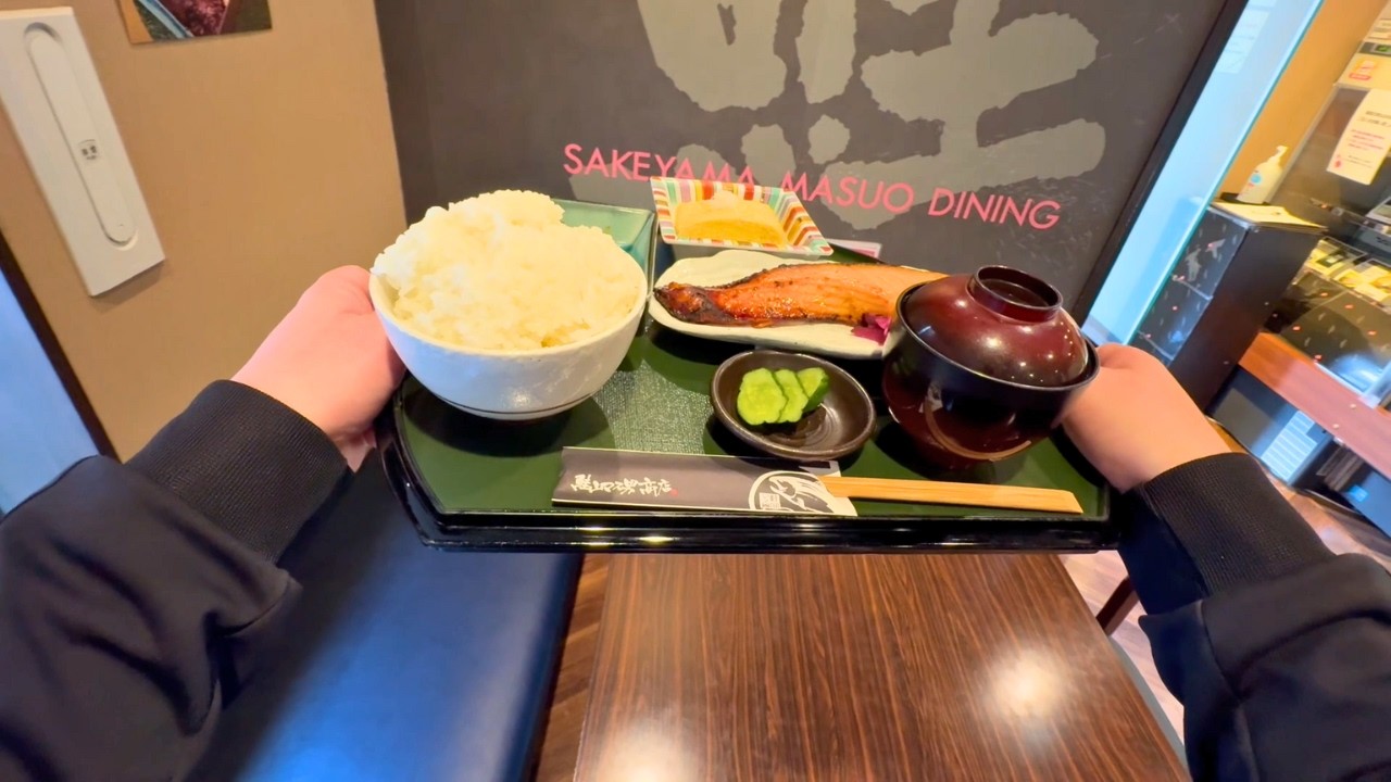 A Japanese nurse eating grilled salmon set meal for lunch on her day off