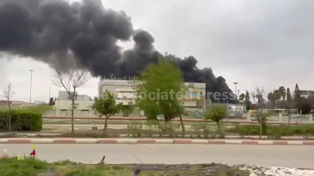 Black smoke cloud rises from fire at factory hit by missile fragment in southern Israel