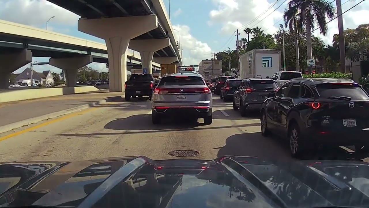 Driving in Miami on NW 25th Street towards the Miami Airport cargo area.