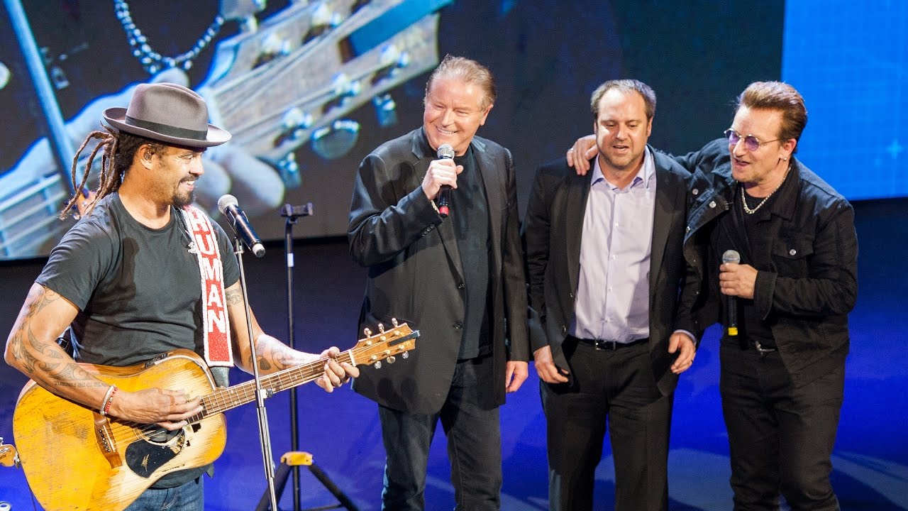 Michael Franti, Bono, Don Henley, and Jeff Skoll perform 