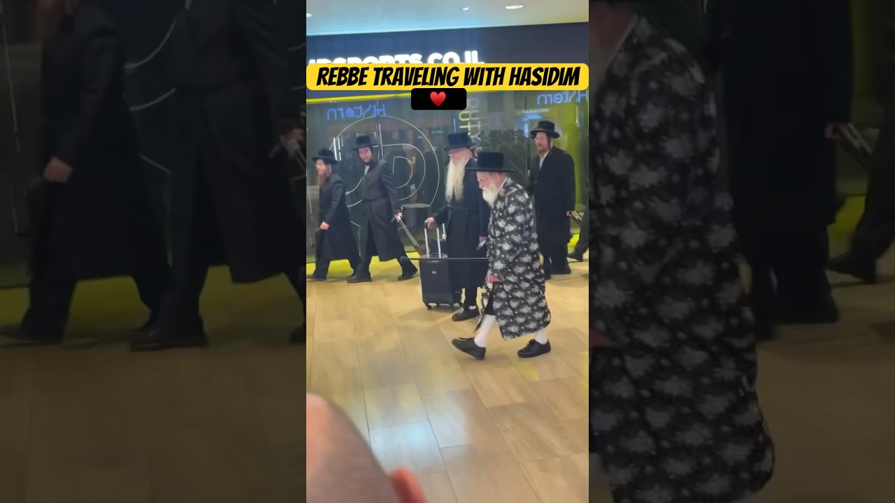 Hasidic Rebbe walking through airport as his people sing 🎶