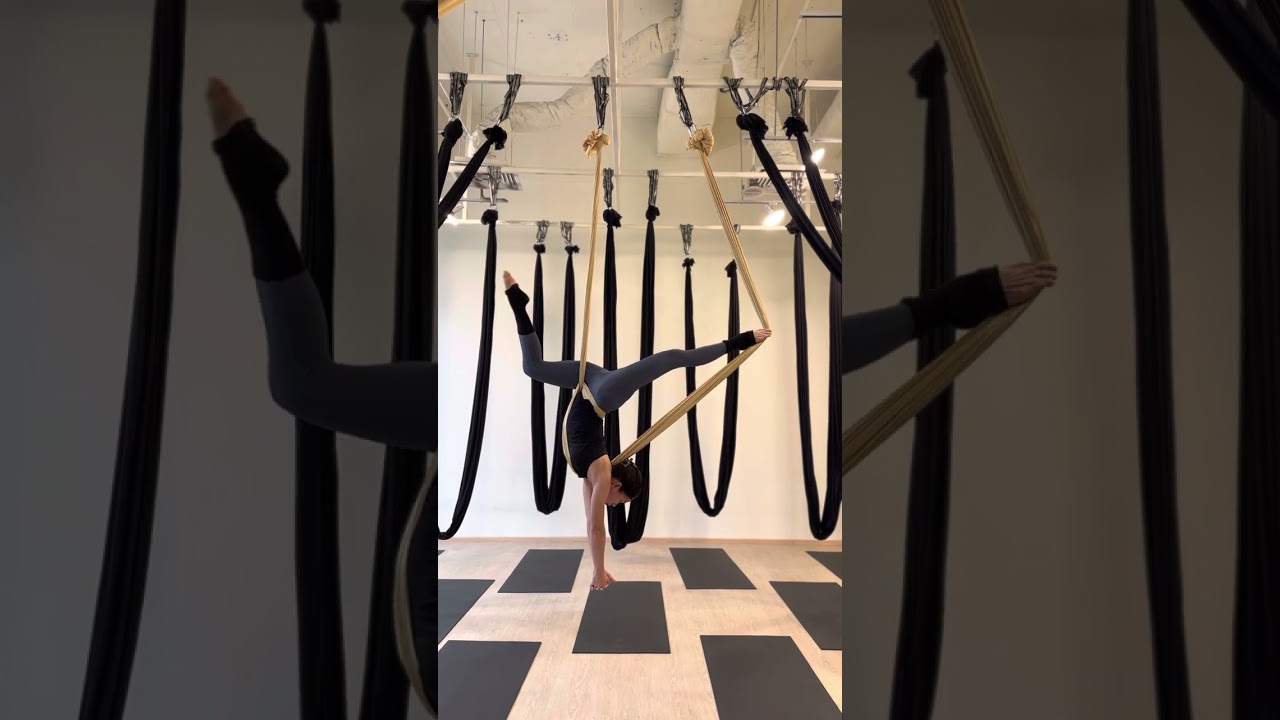 Aerial yoga hammock static flow with cross back straddle inversion