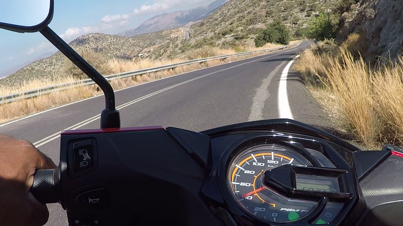 Driving through Mountains of Greece Crete on motorscooter Honda F1