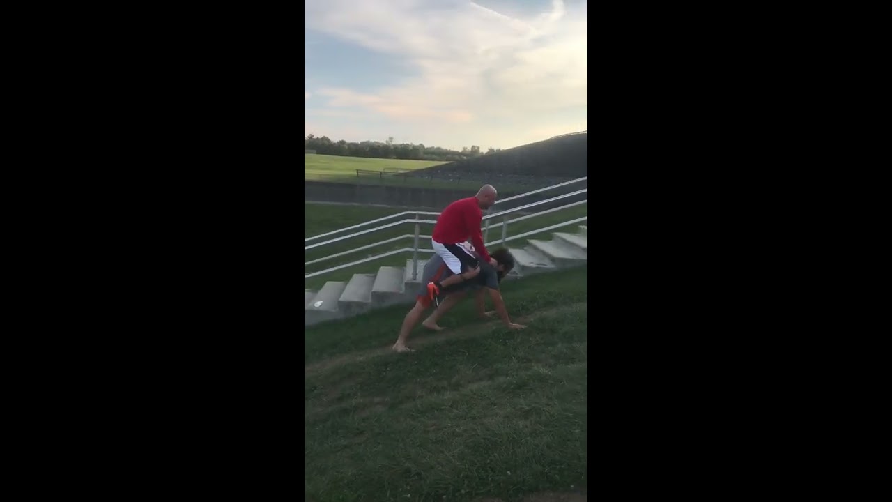 Nick &ldquo;Afrozilla &ldquo;Gaston doing bear crawls uphill with Scottie &ldquo;The Dream&rdquo; Weaver on his back