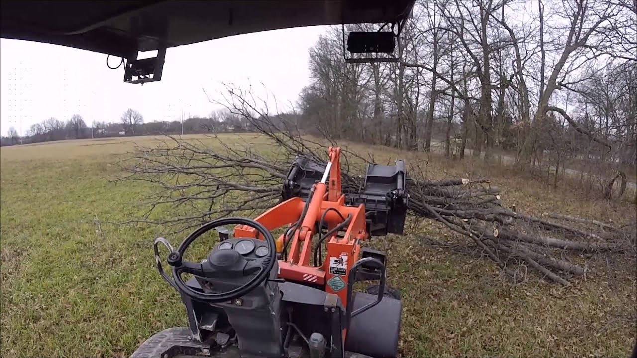 kubota r420 cleaning up a tree