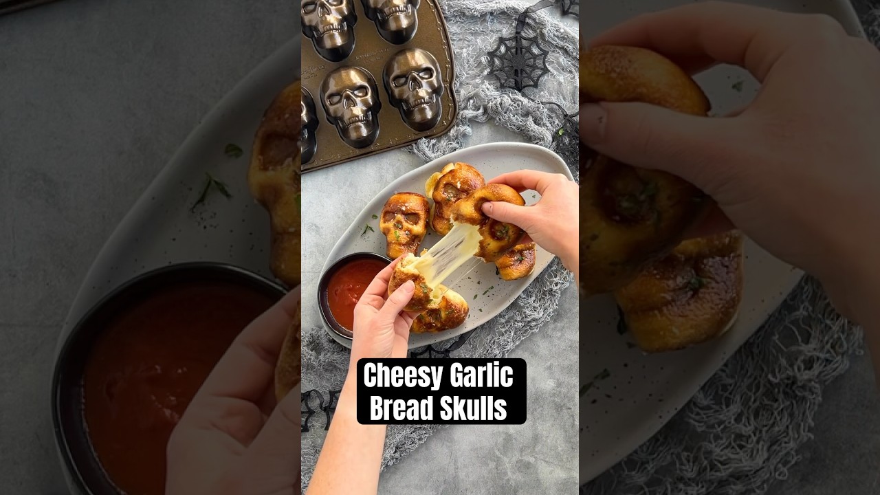 Cheesy Garlic Bread Skulls for Halloween made in Haunted Skull Cakelet Pan! Recipe on our website!