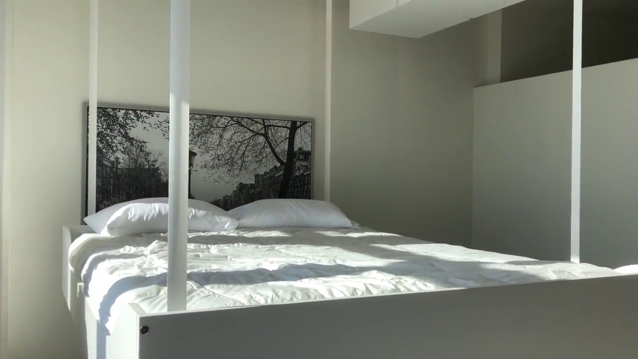 Space-saving smart bed drops from ceiling